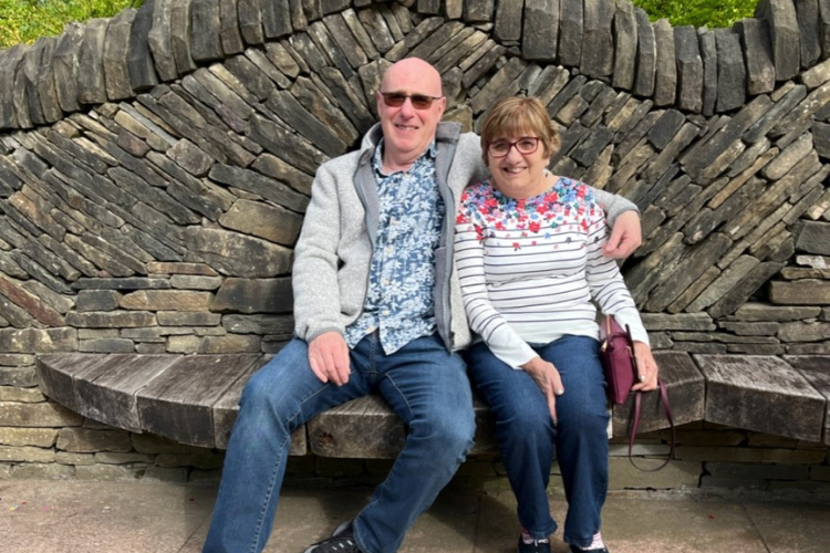 Picture of David and Helen Taylor on an ornate dry-stone bench