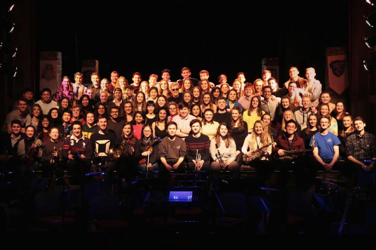 The cast of medics musical all sat on a stage