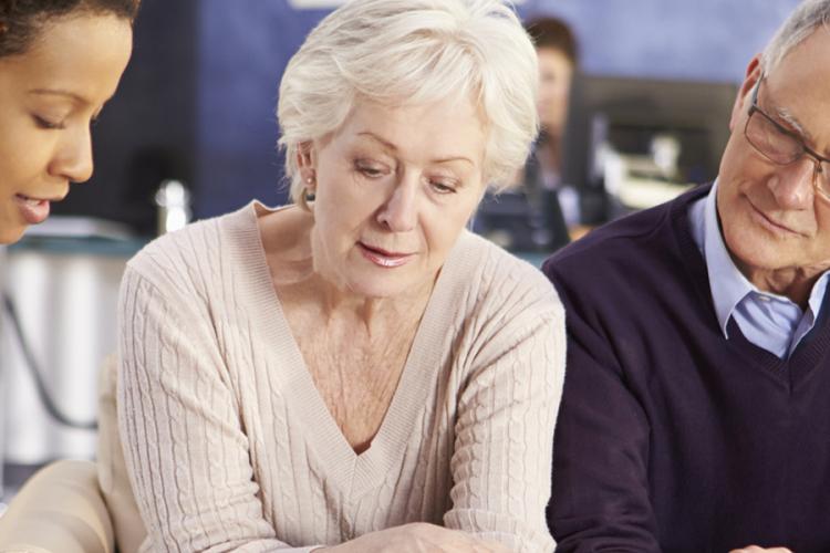 Nurse talking to older couple