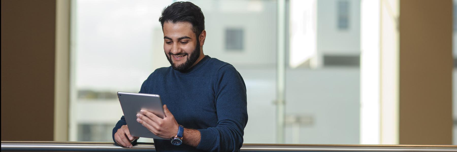 A person happily scrolling through an iPad