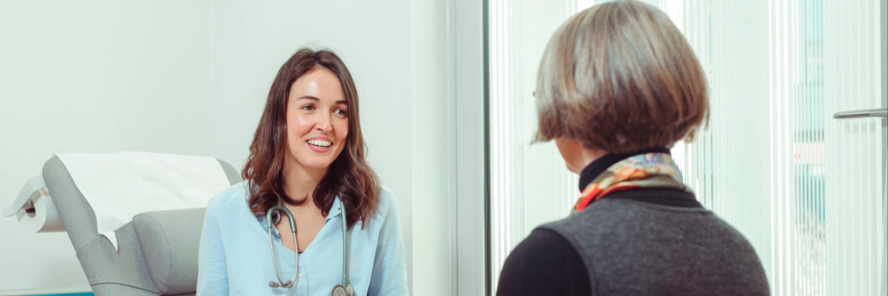 young female Rowling fellow chatting to a patient