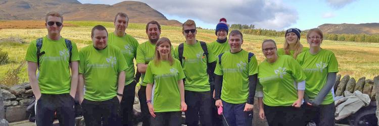 Group of fundraisers in Anne Rowling T-shirts with hills in background