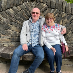 Picture of David and Helen Taylor on an ornate dry-stone bench