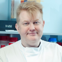 Picture of David Story with a laboratory background