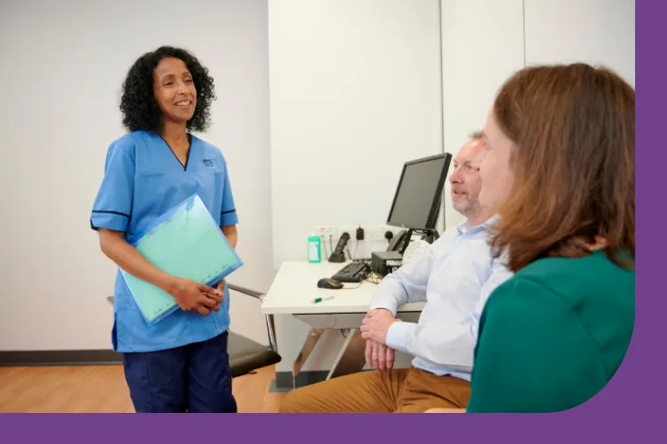 Nurse with patient and partner in a consultation room